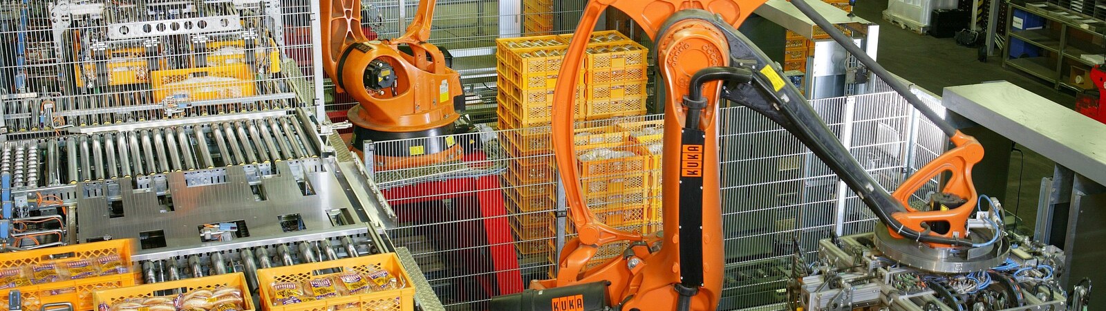 Industrial robots palletising packaged products on an automated production line